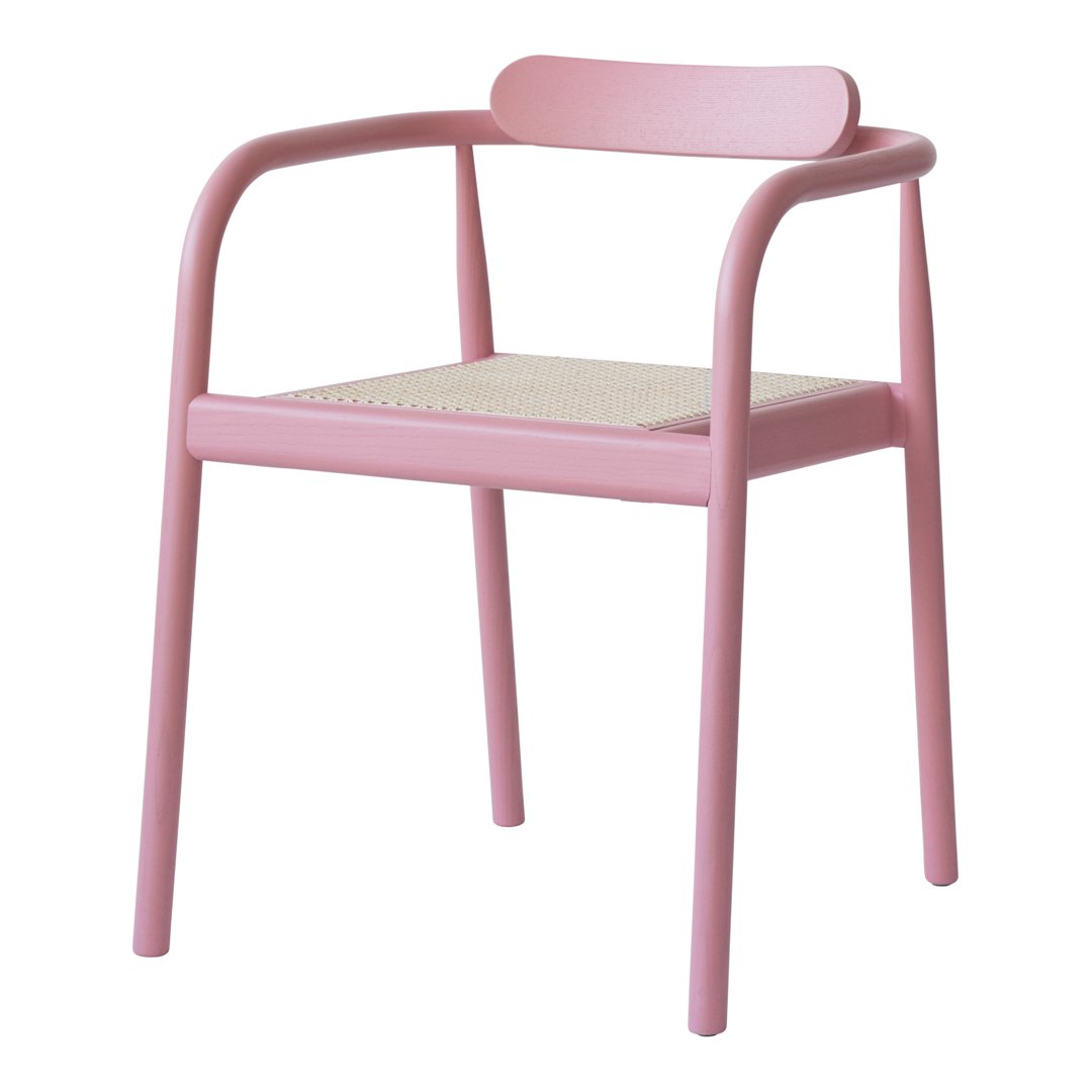 Pink chair with a minimalist design and natural woven seat, perfect for modern decor.