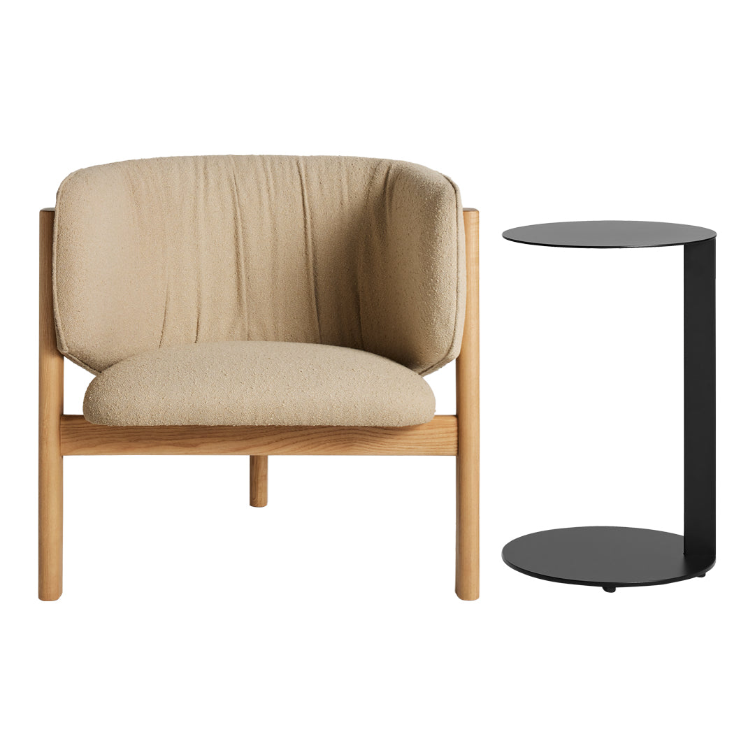 Beige upholstered chair with smooth black side table, featuring a minimalist design and natural wood accents.