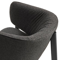 Dark grey textured fabric with a smooth, curved design and sleek black legs.