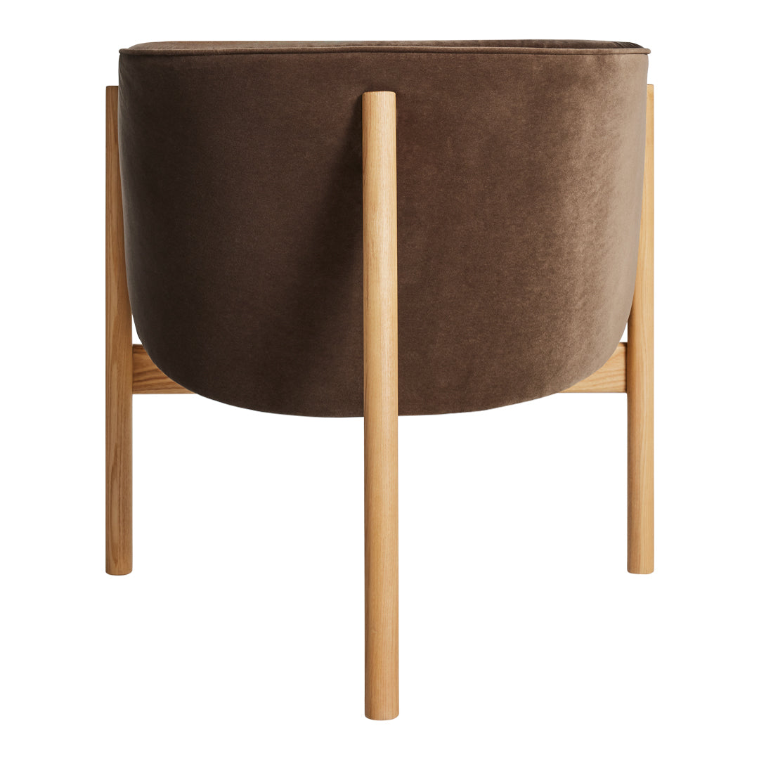 Brown velvet planter pot with wooden legs, featuring a smooth surface and minimalist design.
