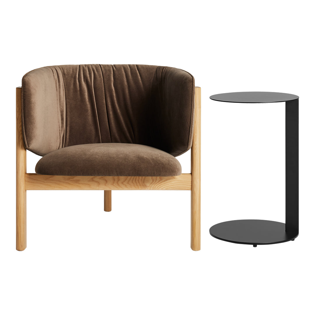 "Brown velvet chair with a natural wood frame and a sleek black side table, minimalist design."
