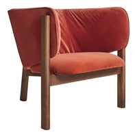 Soft velvet chair in warm orange tones with a smooth, minimalist design and wooden legs. Perfect for modern decor.
