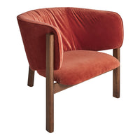 Velvety rust orange chair with a rounded back, complemented by dark wooden legs for a warm and cozy aesthetic.