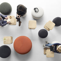 Colorful seating options featuring orange, black, grey, and natural wood patterns in a modern setting.