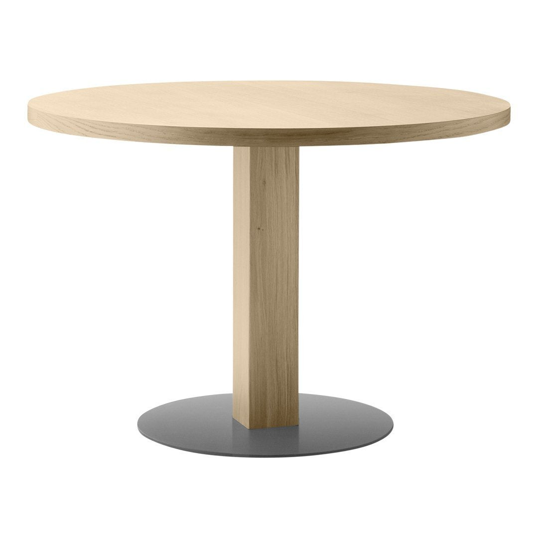 Round wooden table with a natural oak finish and a sleek, contrasting black metal base. Simple and modern design.