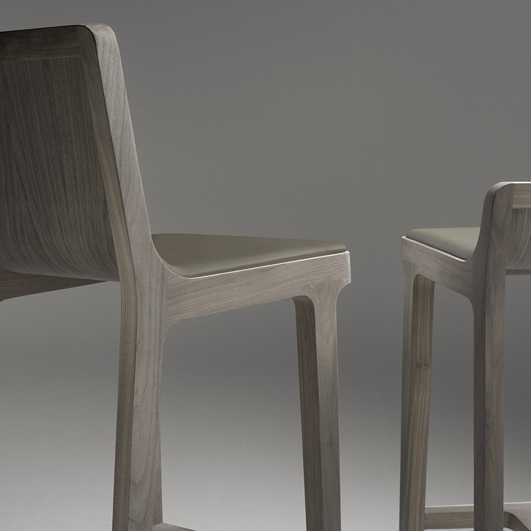 Modern wooden chairs in a sleek gray finish with a minimalist design. Ideal for contemporary decor.