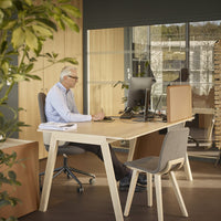 Light wood desk with gray chair, featuring a modern and minimalist design in a bright, natural workspace.