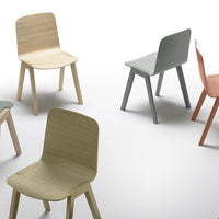 "Set of four minimalist chairs in soft pastel colors: beige, gray, green, and coral."