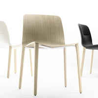 Three modern chairs in white, light wood, and black, showcasing sleek lines and minimalistic design.