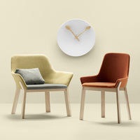 "Two stylish chairs: one in soft yellow with grey cushion, the other in warm orange, against a neutral backdrop."