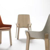 Three modern chairs featuring orange, beige, and light gray upholstery with wooden legs, showcasing unique patterns and textures.