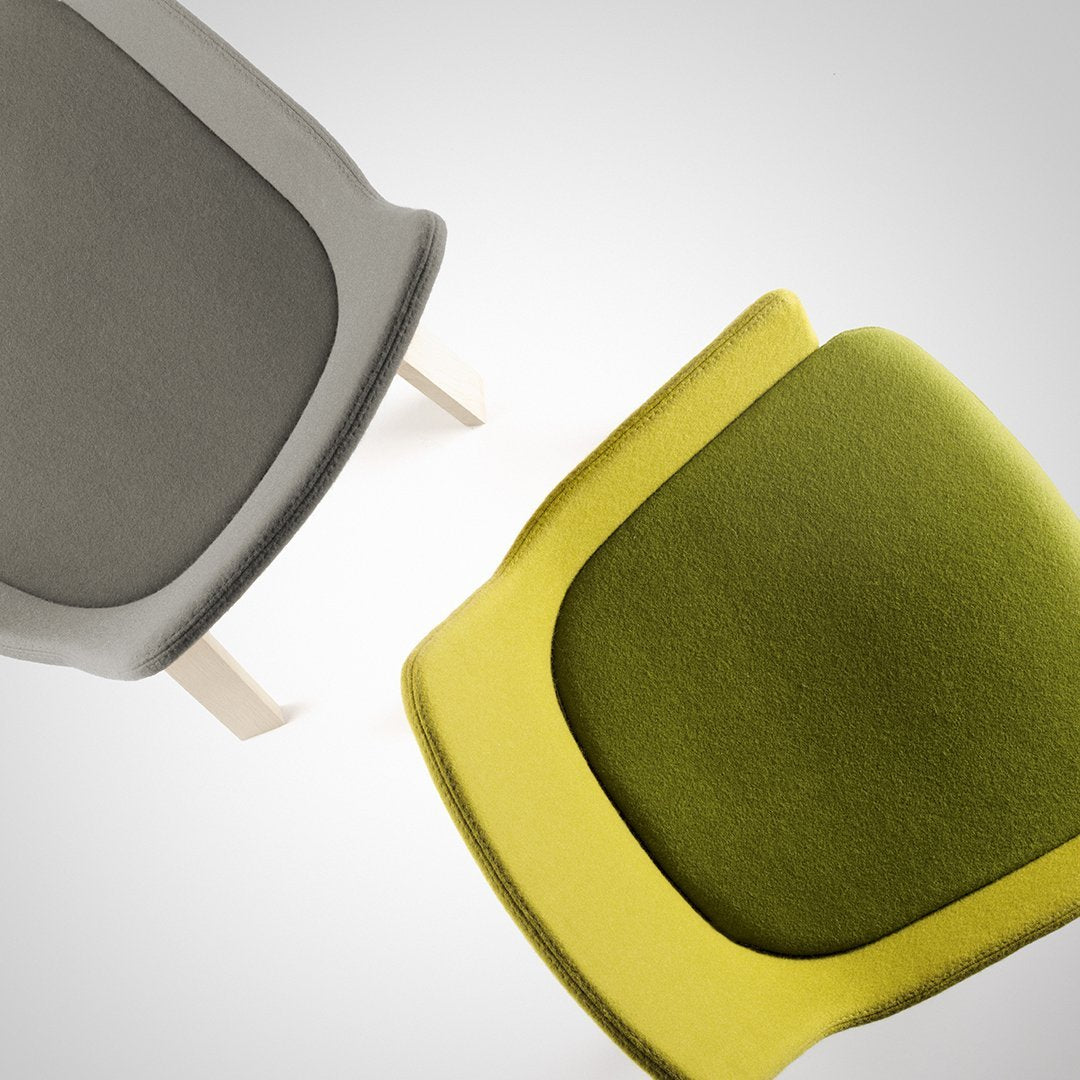 Modern chairs featuring gray and vibrant green upholstery with sleek, minimalist designs. Perfect for contemporary decor.