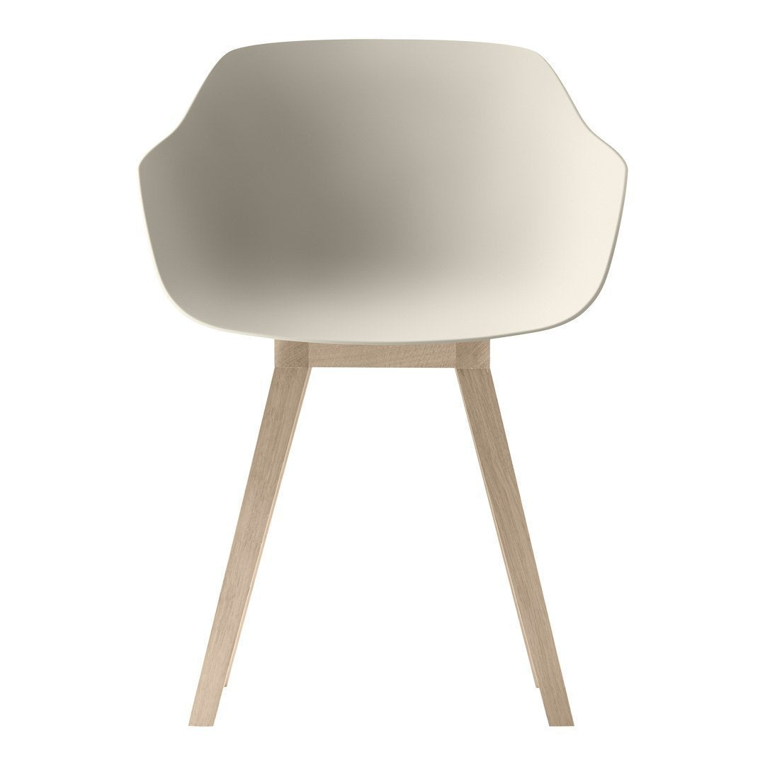 Light cream chair with smooth, minimalist design and wooden legs, perfect for modern styling.