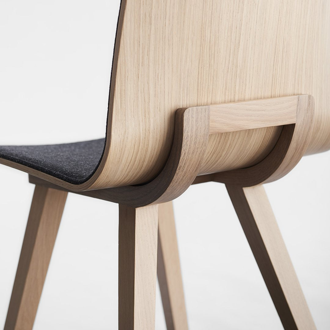 Natural wood with light grain and contrasting dark gray upholstery, featuring a sleek, modern design.