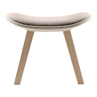 Soft beige upholstered stool with a smooth curved seat and natural wood legs, perfect for modern interiors.