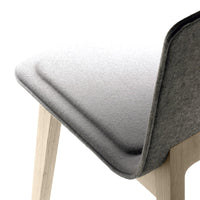 Gray textured fabric chair back with light wood legs, featuring a smooth, minimalist design.