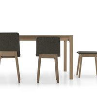 Wooden dining table with light wood frame and dark gray upholstered chairs, featuring clean lines and minimalist design.