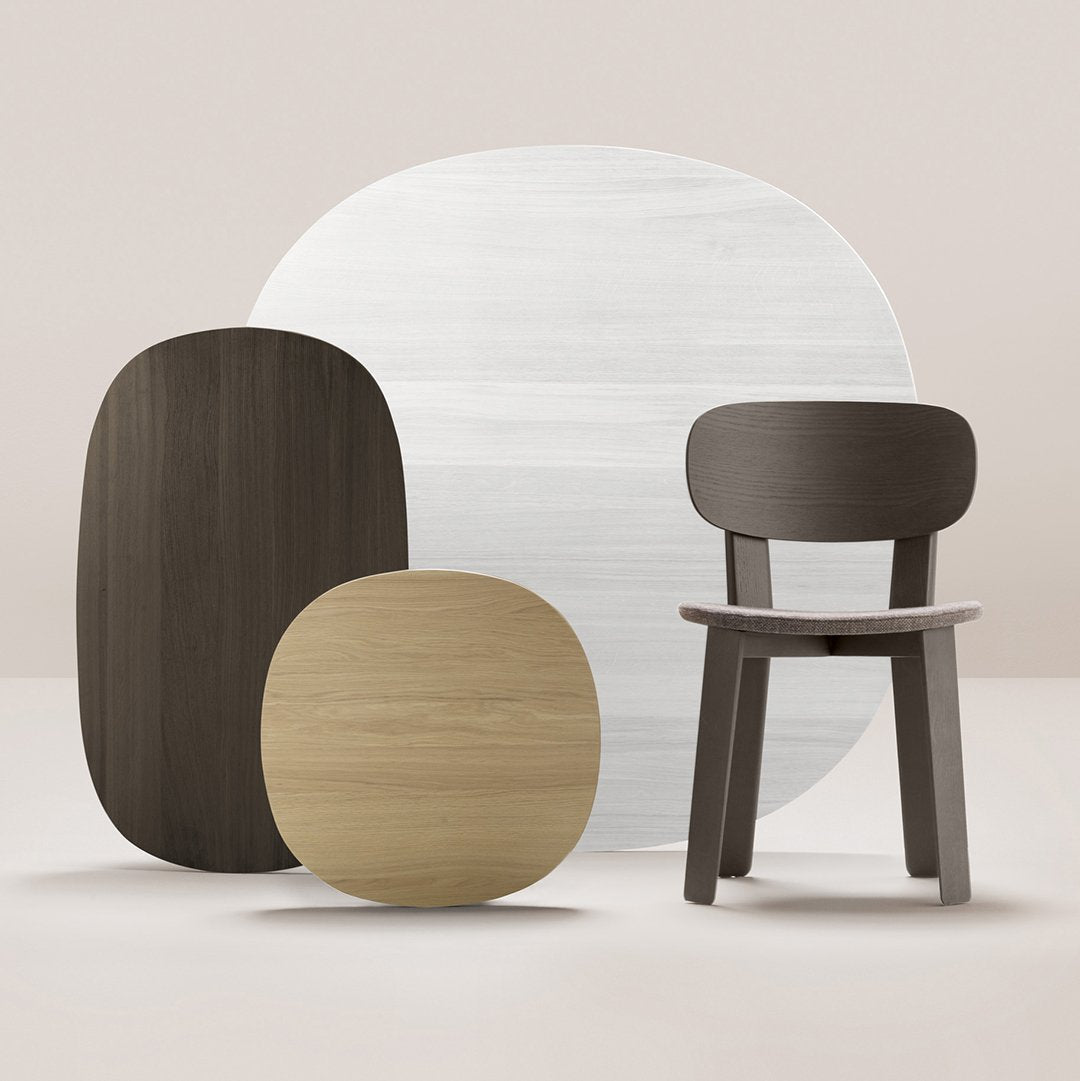 "Minimalist furniture set featuring dark wood, light wood, and white circular patterns on a soft beige background."