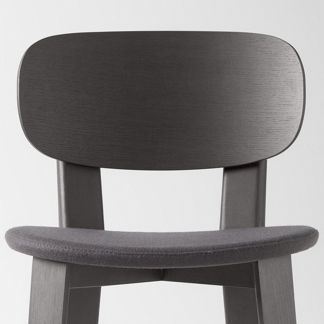 Sleek gray wood chair with a smooth, brushed finish and a soft gray upholstered seat. Modern, minimalist design.