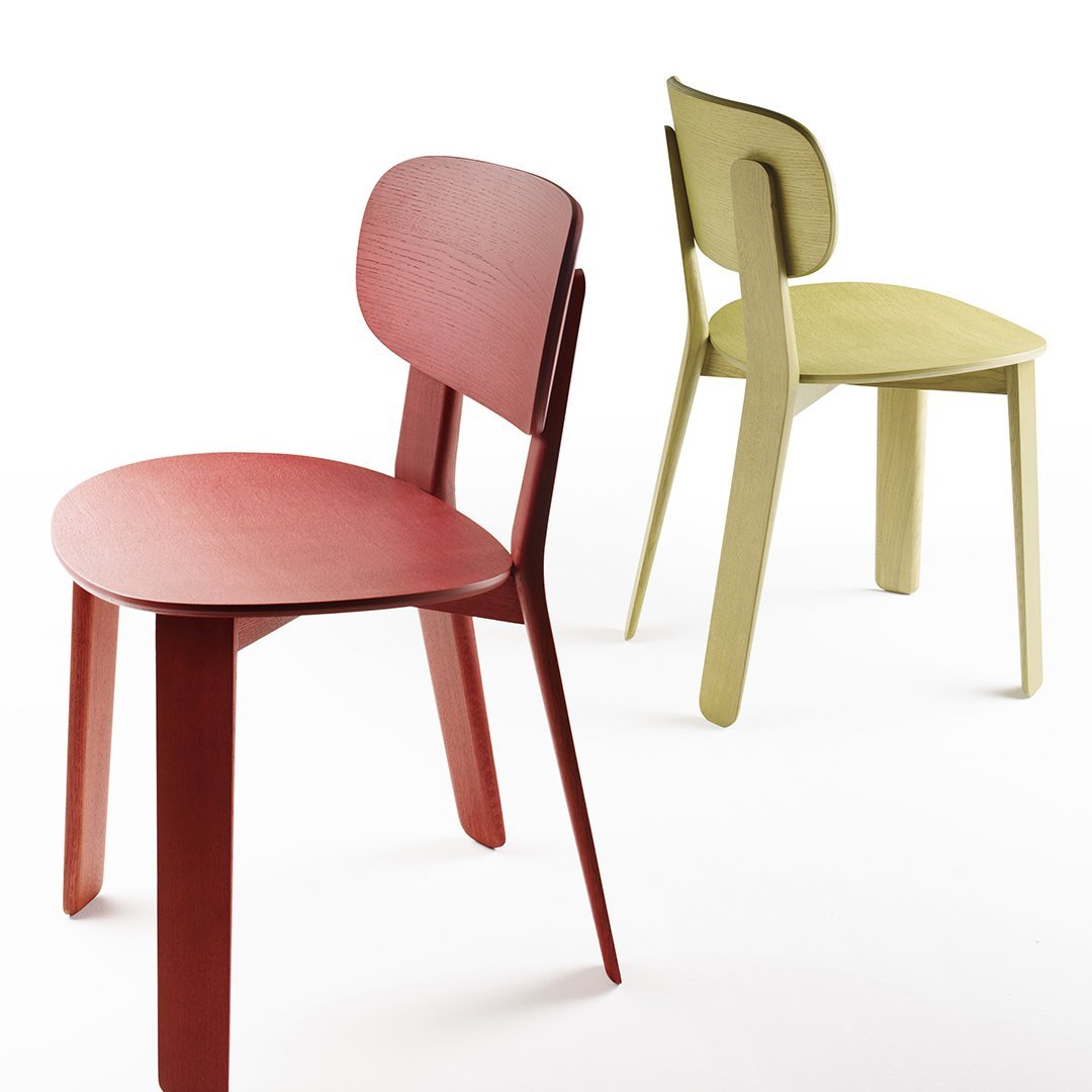 Red and green minimalist chairs featuring smooth, rounded designs and solid colors against a white background.