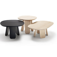 Set of three modern coffee tables in black and natural wood finishes, featuring smooth, rounded edges and unique shapes.