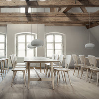 Light wooden furniture with soft gray accents and white walls, showcasing a minimalist and airy design.