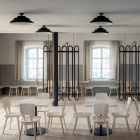 Bright neutral tones with black accents and elegant wood finishes, featuring minimalist furniture and simple patterns.