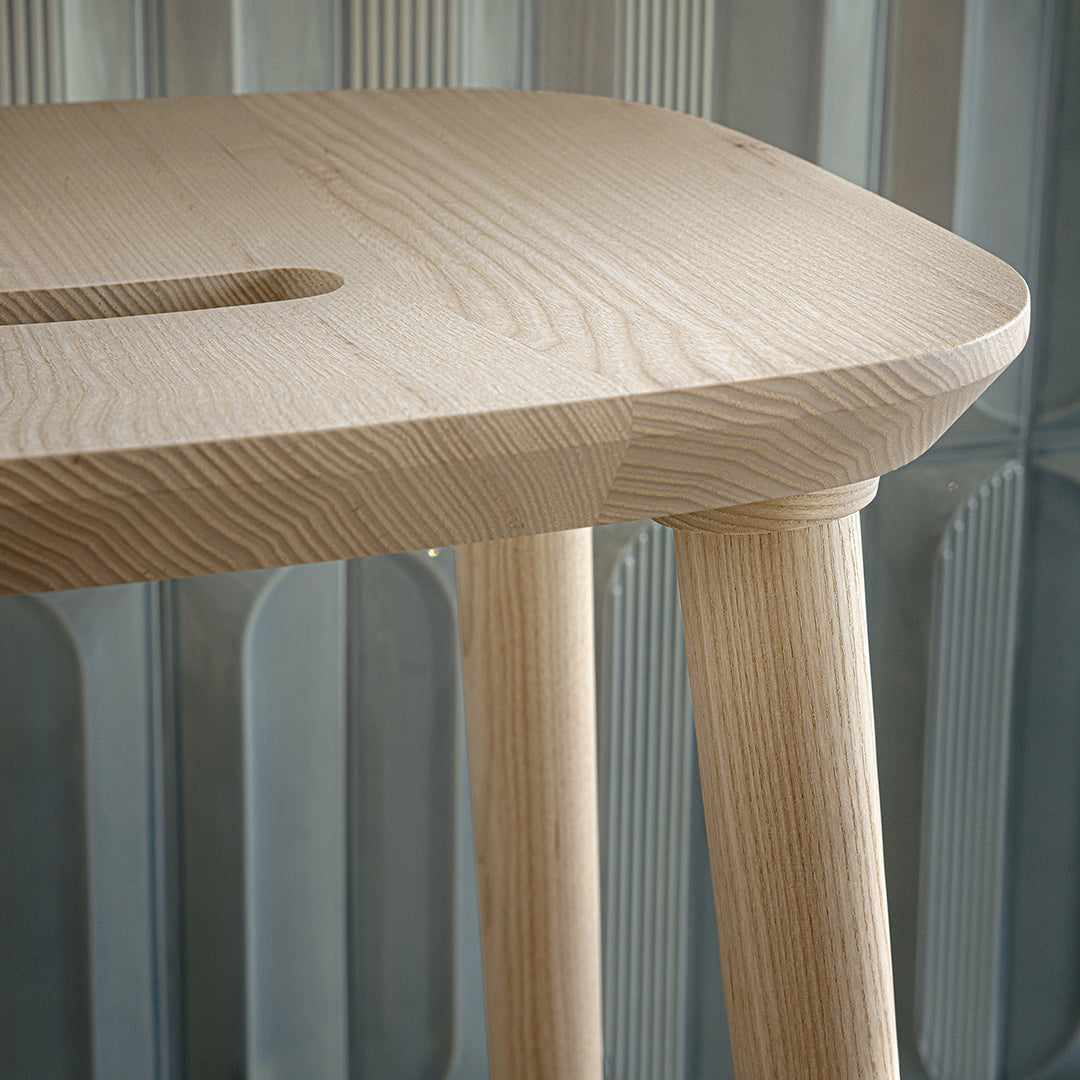 Light ash wood table with a smooth, natural finish and simple, clean lines. Minimalist design complements any decor.