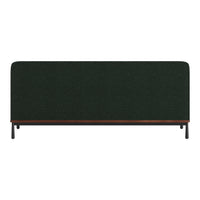 Dark green upholstered backrest with textured fabric and a wooden base against sleek black legs.