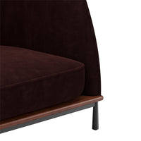 Burgundy velvet upholstery with smooth texture and dark wood base, featuring a modern and elegant design.