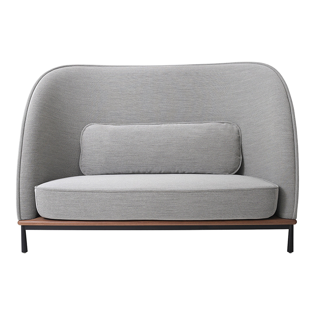 Gray upholstered sofa with smooth texture and rounded back, featuring a matching lumbar pillow and minimalist design.