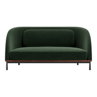 Green velvet sofa with smooth upholstery and a minimalist design, featuring a contrasting wood base.