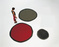 Round area rugs in red, dark gray, and light gray with smooth, contrasting edges. Perfect for modern decor.