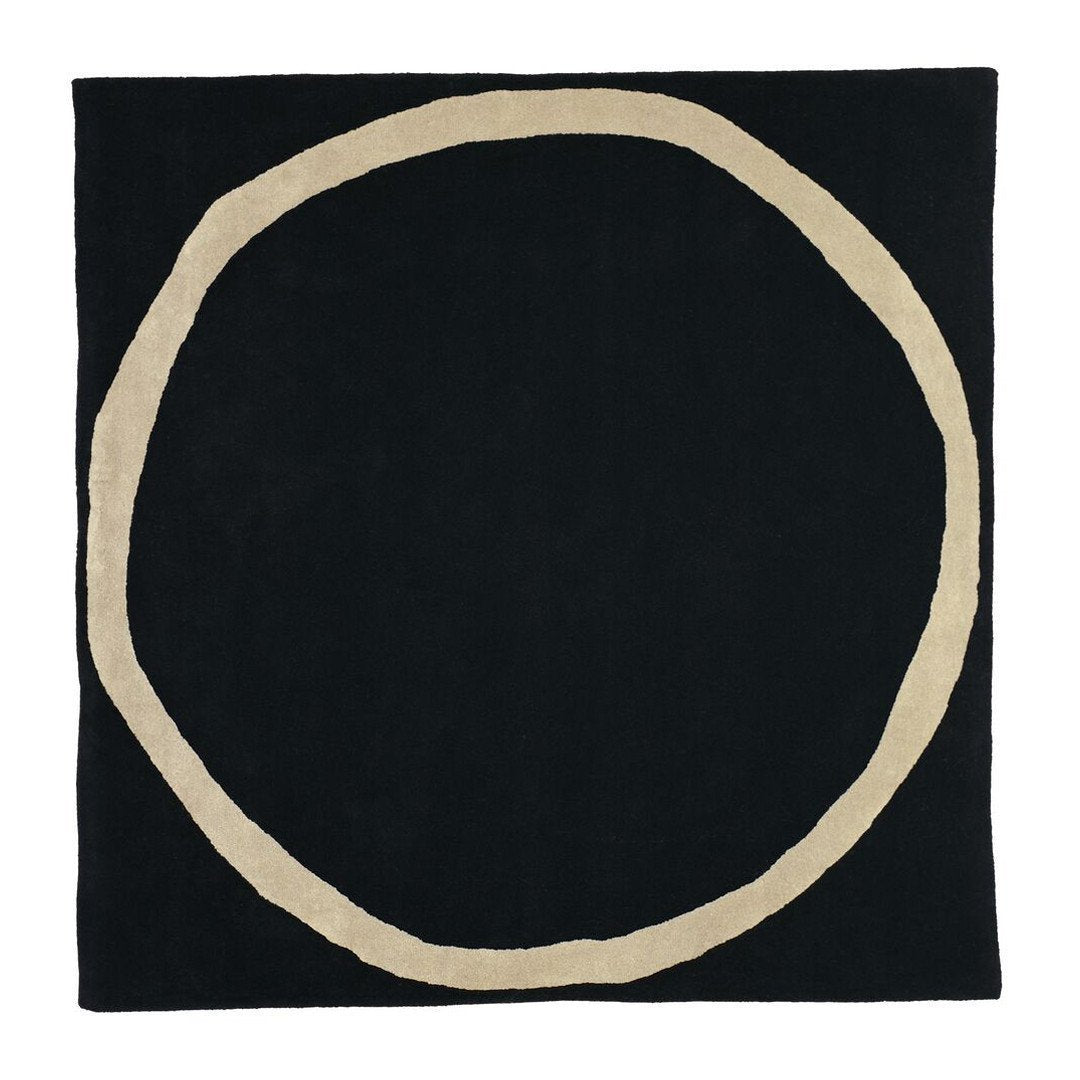 Black square rug with a contrasting beige circular pattern at the center, stylish and modern design.