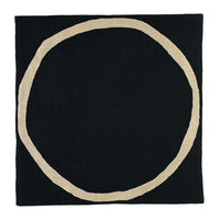 Black square rug with a contrasting beige circular pattern at the center, stylish and modern design.