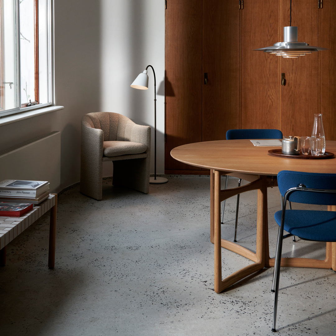 Modern interior featuring earthy wood tones, soft beige, and rich blue accents on furniture and decor.
