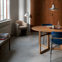 Modern interior featuring earthy wood tones, soft beige, and rich blue accents on furniture and decor.