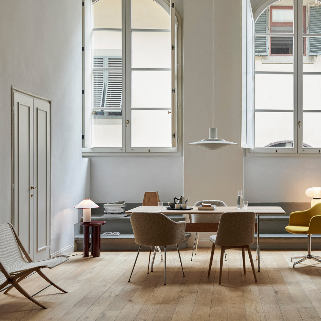 Neutral tones with light gray walls, wooden flooring, and pops of yellow and brown in modern furniture pieces.