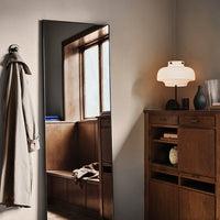"Neutral tones with warm wood accents, reflecting modern minimalist design in a cozy interior setting."
