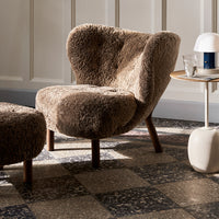 Textured brown chair with a cozy, fuzzy pattern, complemented by a contrasting patterned floor.