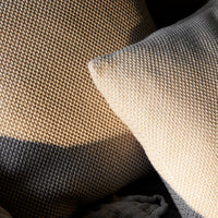 Textured beige and gray woven cushions with a modern pattern, adding a stylish touch to any decor.