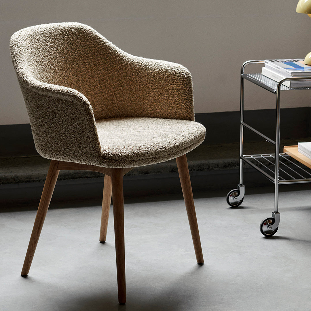 Beige textured armchair with light wooden legs, perfect for modern interiors. Elegant and stylish design.