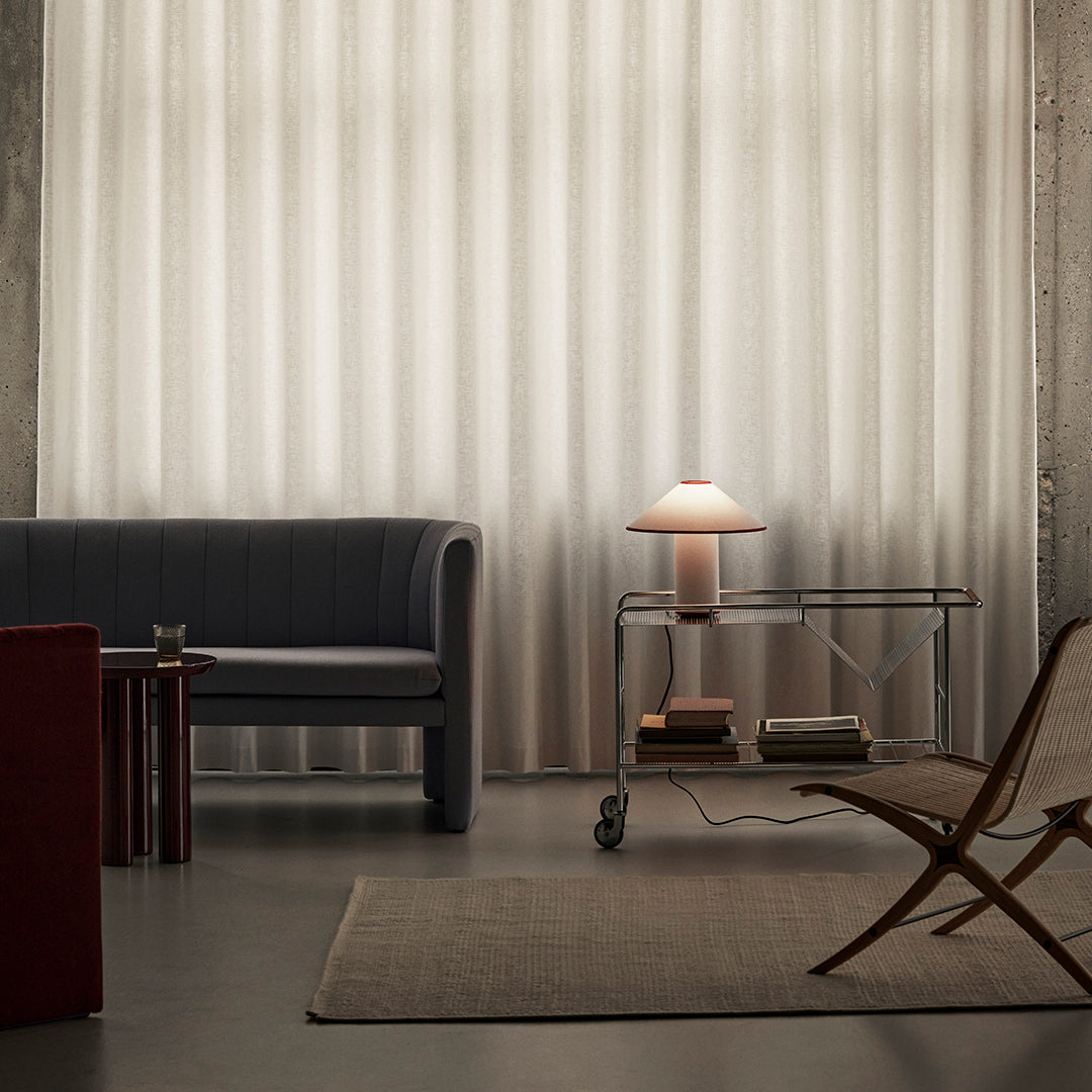 "Soft beige vertical striped curtains enhancing a modern gray and red living room decor."