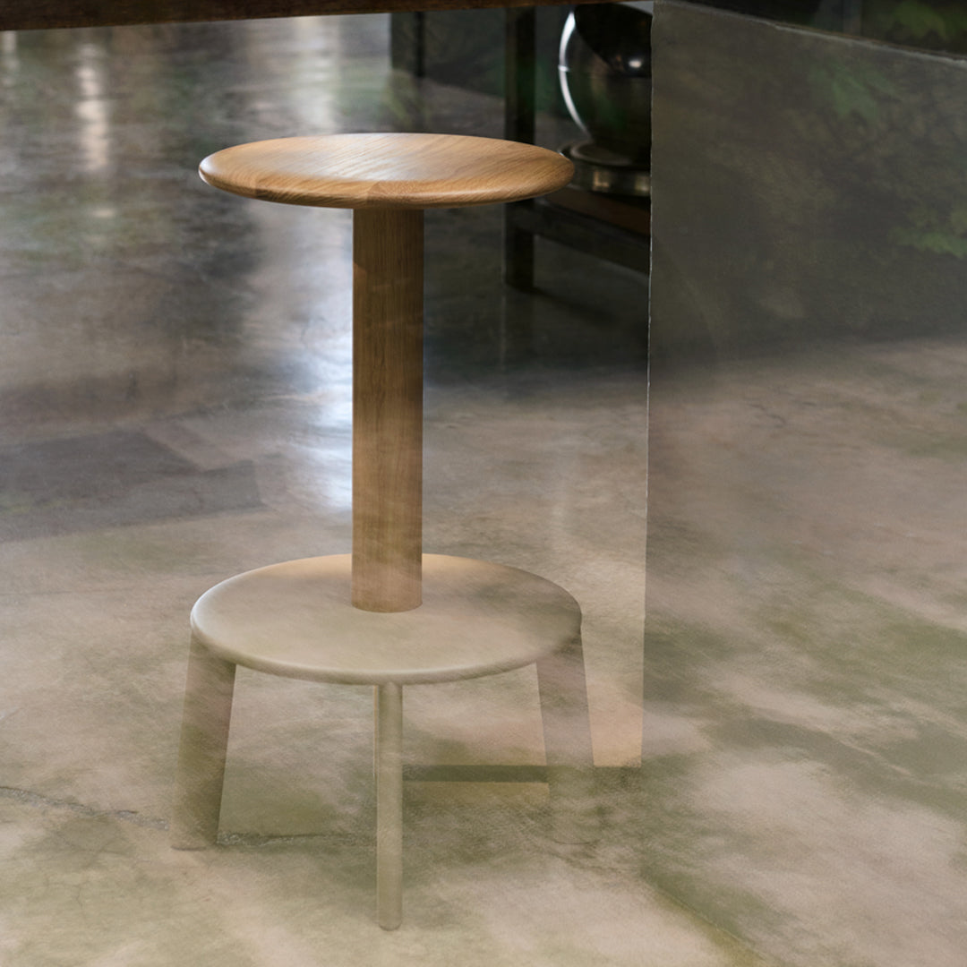 Light wood stool with a smooth, natural finish; circular top and base featuring subtle textures and warm tones.