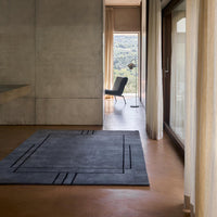 Modern black area rug featuring geometric lines and patterns, adding a sleek touch to contemporary interiors.