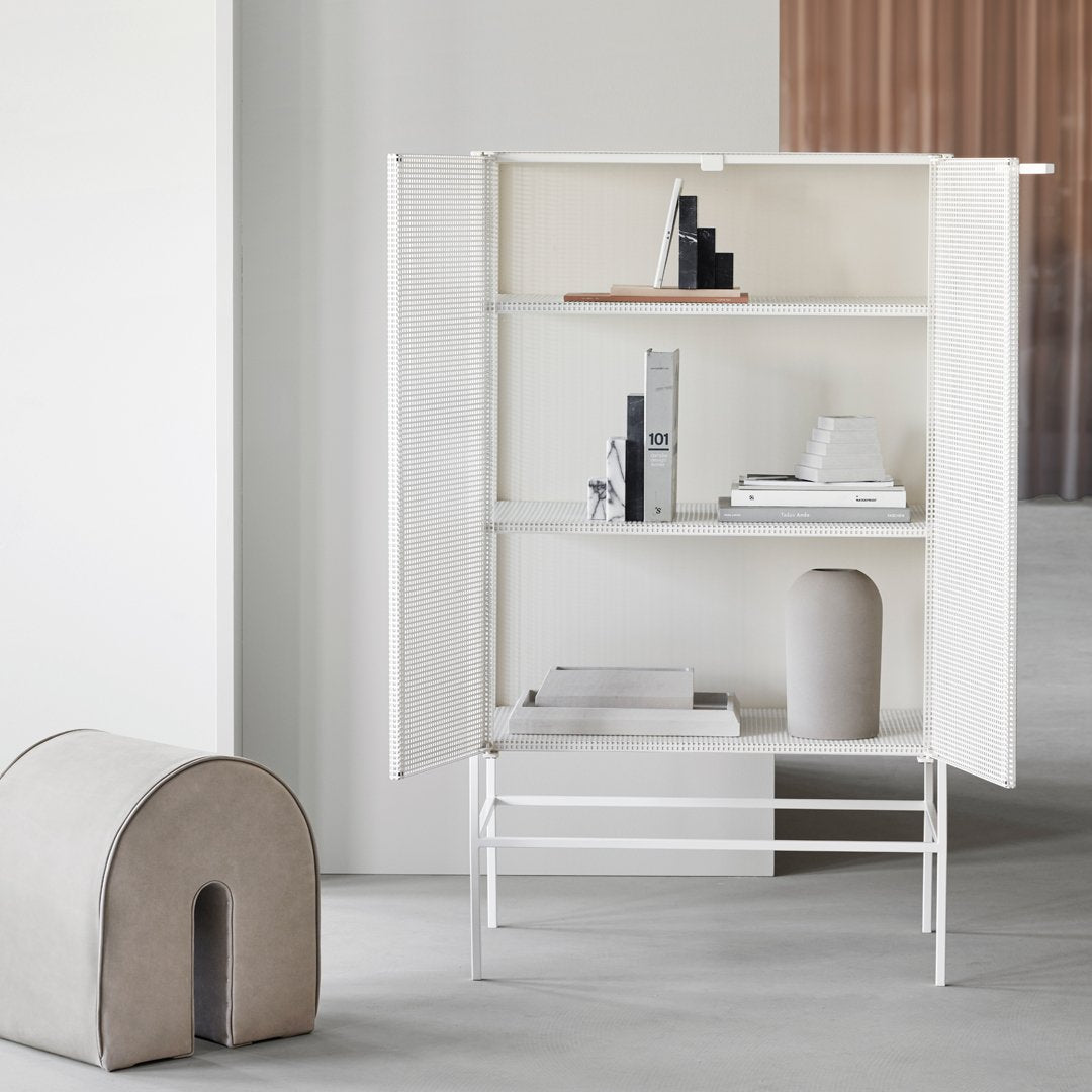 Modern white cabinet with minimalist design, featuring clean lines and a smooth finish, set in a neutral-toned interior.