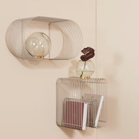 Modern wire wall shelves in sleek silver, featuring minimalist design with circular and rectangular patterns.