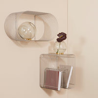 Modern silver wire wall shelves with rounded shapes, showcasing a minimalist design against a soft beige background.