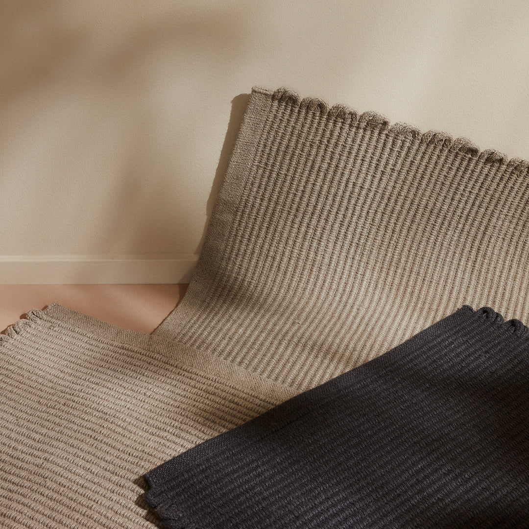 Textured beige and navy striped fabric swatches, showcasing subtle ribbed patterns in a neutral color palette.