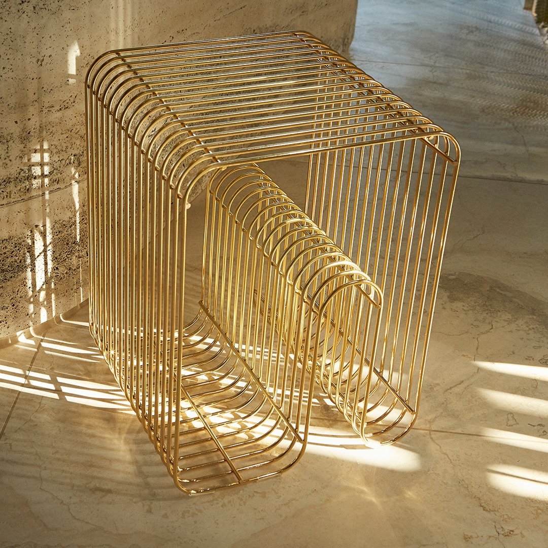 Gold geometric side table with sleek lines and a minimalistic design, creating a modern aesthetic.